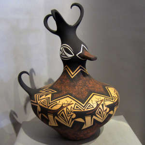 Click to see a larger version Deer-with-heart-line and geometric design on a polychrome duck pot