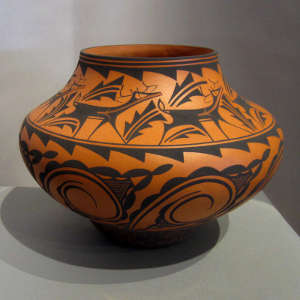 Deer and heart line design on a red pot