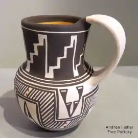 Fine line and geometric design on a polychrome pitcher