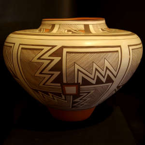 Fine line and geometric design on a polychrome jar