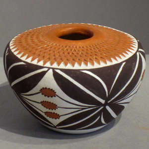 A geometric design and corrugated flat top on a polychrome jar