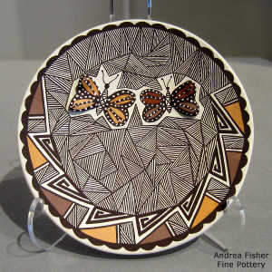 Butterfly, fine line and geometric design on a polychrome plate