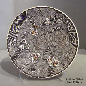 Butterfly, fine line and geometric design on a polychrome plate