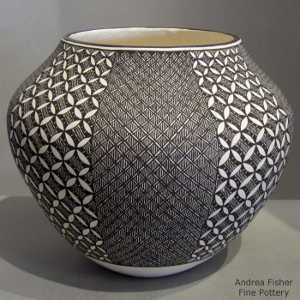 Fine Line and geometric design on a black and white jar