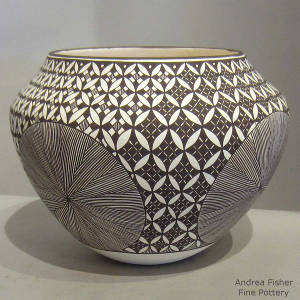 Medallion, fine line and geometric design on a black and white jar
