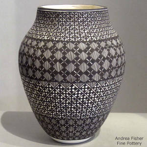 Fine line and geometric design on a black and white jar