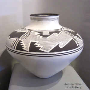 4-panel black Mimbres-style designs on a white jar