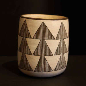 Fine line and geometric design on a black and white jar