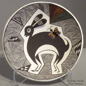 Mimbres rabbit and fine line designs decorate a polychrome plate with a raised butterfly