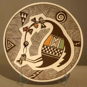 Mimbres-style bird eating fish on a polychrome plate with fine line and geometric design
