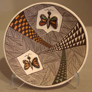 Butterfly and geometric design with raised butterfly wings on a polychrome plate