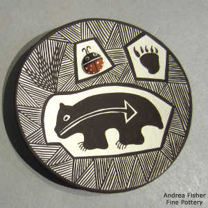 Fine line, bear paw, bear, heart line, lady bug and geometric design on a polychrome plate