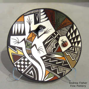 Lady bug, lizard and geometric design on a polychrome plate
