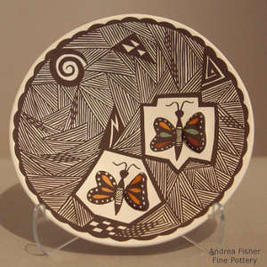 Butterfly, fine line and geometric design on a polychrome plate