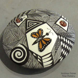 Lady bug, butterfly and geometric design on a polychrome seed pot