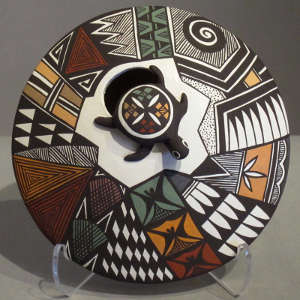 Geometric design and raised turtle on a polychrome seedpot