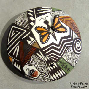 Butterfly, lady bug and shard design on a polychrome seed pot