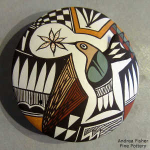 Hummingbird, flower, shard and geometric design on a polychrome seed pot