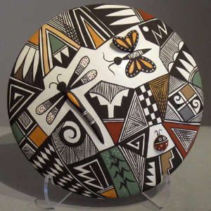 Geometric design and raised dragonfly body, ladybug and butterfly wing on a polychrome seedpot