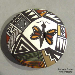 Butterfly and shard geometric design on a polychrokme seed pot