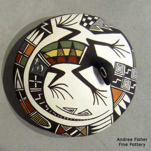 Lizard and geometric design on a polychrome seed pot
