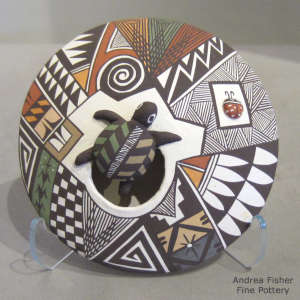 Turtle, ladybug and geometric design on a polychrome seed pot