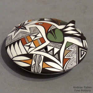 Hummingbird, lady bug and geometric design on a polychrome seed pot