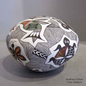 A Mimbres rabbit, butterfly and geometric design on a polychrome seed pot