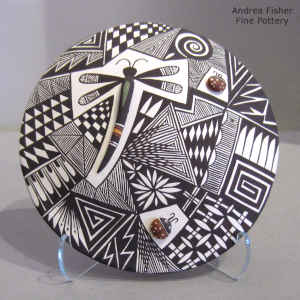 Dragonfly, lady bugs, fine line and geometric design on a polychrome seed pot