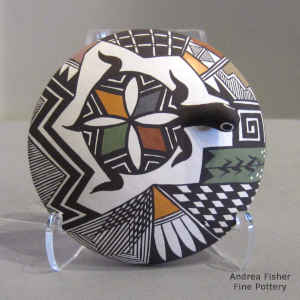 Turtle, lady bug and geometric design on a polychrome seed pot