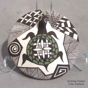 Turtle, lady bug and geometric design on a polychrome seed pot