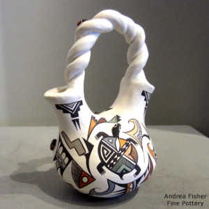 Lizard, butterfly, lady bug, turtle and geometric design on a wedding vase with a twisted handle