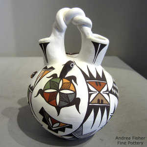 Lady bug, butterfly, shard and geometric design on a polychrome jar