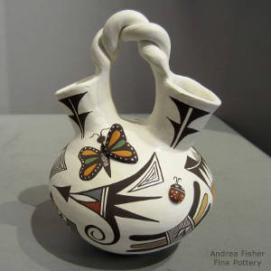 Butterfly, lady bug and geometric design on a polychrome wedding vase