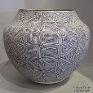 Fine line snowflake design on a black and white jar