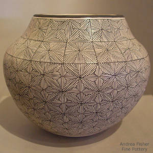 Fine line snowflake design on a black and white jar