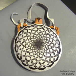 Fine line and swirl geometric design on a polychrome canteen