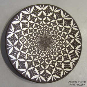 Fine line and geometric design on a black and white plate