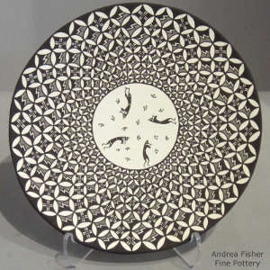 Kokopelli and geometric design on a black and white plate