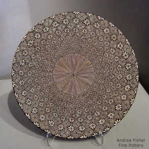 Fine line and geometric design on a black and white plate