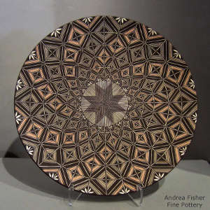 Fine line and geometric design on a polychrome plate