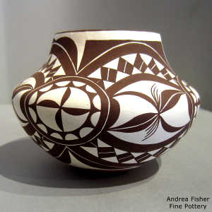 Black and white medallion and geometric design on a polychrome jar