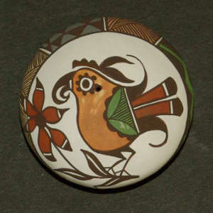 Parrot, flower and geometric design on a polychrome seed pot