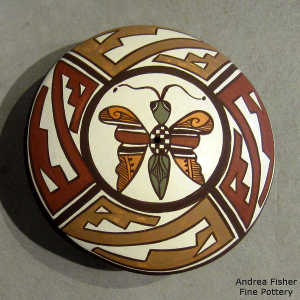 Kiva step, dragonfly and geometric design on a polychrome seed pot
