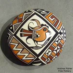 Parrot and geometric design on a polychrome seed pot