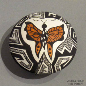 Butterfly, fine line and geometric design on a polychrome seedpot