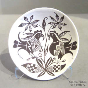 Parrot, floral and geometric design on a black and white plate