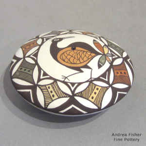 Bird, flower and geometric design on a polychrome seed pot