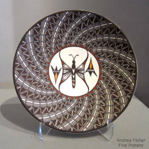 Butterfly medallion and swirl geometric design on a polychrome plate