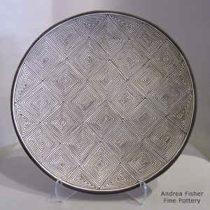 Fine line geometric design on a black and white plate